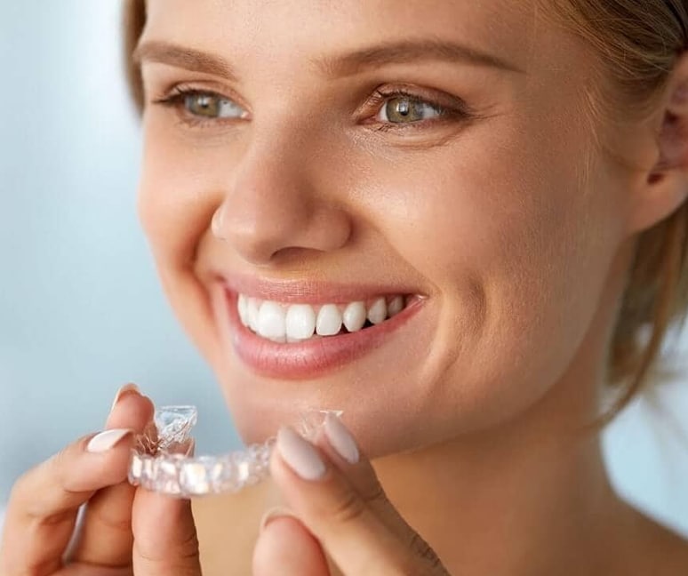 A smiling women having  a Invisalign aligners for beautiful smile 
